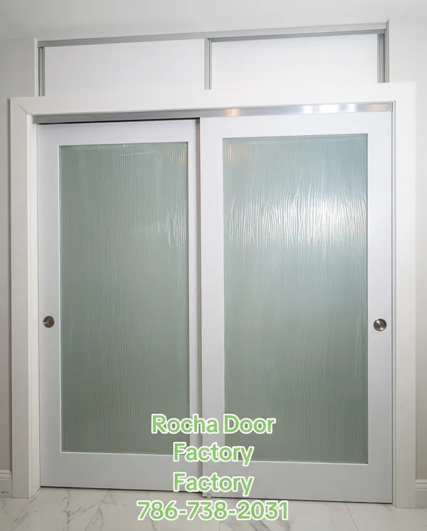 Frosted glass bypass closet doors with white frame
