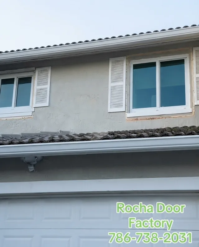 New white impact windows on a two-story home